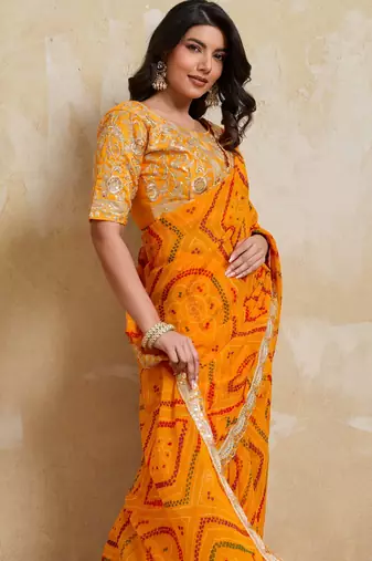 Enchanting yellow georgette bandhej print with cutwork lace border saree with mono banglory silk blouse