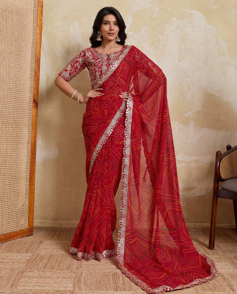 Catching red georgette bandhej print with cutwork lace border saree with mono banglory silk blouse