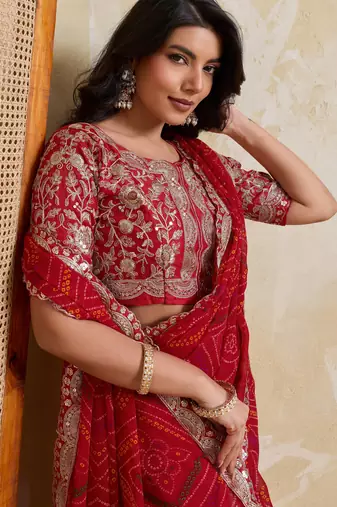 Catching red georgette bandhej print with cutwork lace border saree with mono banglory silk blouse