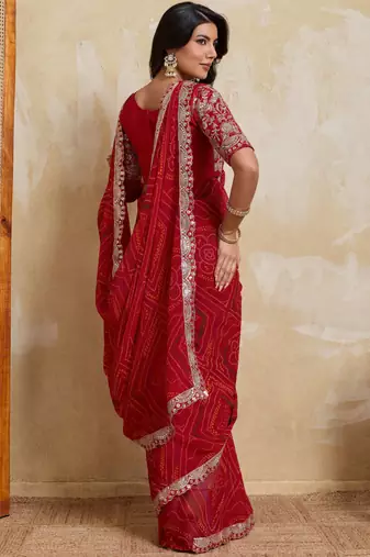 Catching red georgette bandhej print with cutwork lace border saree with mono banglory silk blouse