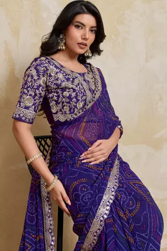 Delightful blue georgette bandhej print with cutwork lace border saree with mono banglory silk blouse