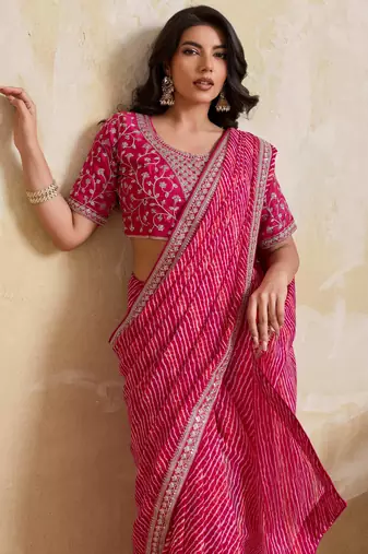 Bewitching pink georgette bandhej print with embroidery work lace border saree with mono banglory silk blouse