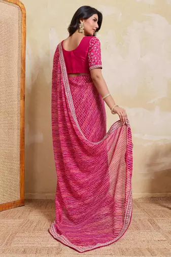 Bewitching pink georgette bandhej print with embroidery work lace border saree with mono banglory silk blouse