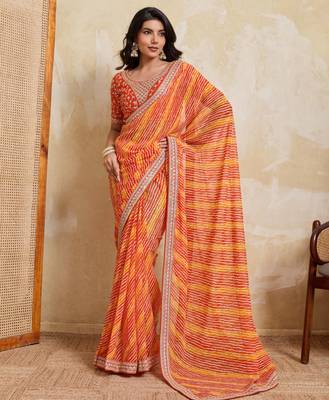 Glamourous orange georgette bandhej print with embroidery work lace border saree with mono banglory silk blouse 1