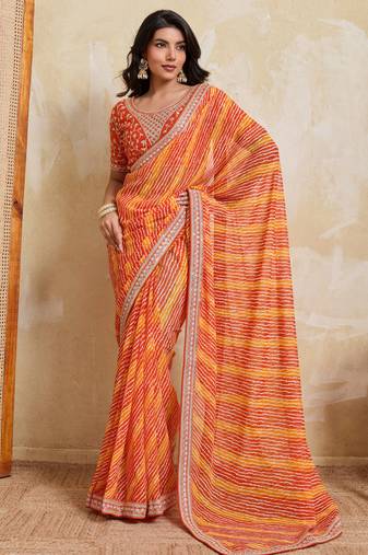 Glamourous orange georgette bandhej print with embroidery work lace border saree with mono banglory silk blouse