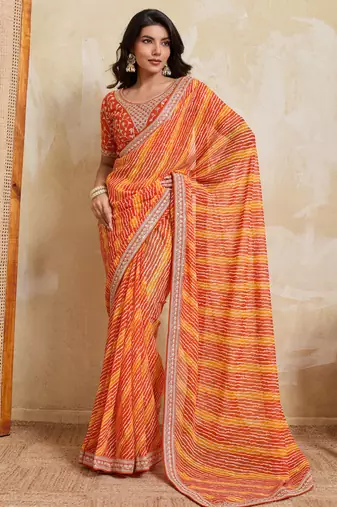 Glamourous orange georgette bandhej print with embroidery work lace border saree with mono banglory silk blouse
