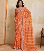 Glamourous orange georgette bandhej print with embroidery work lace border saree with mono banglory silk blouse
