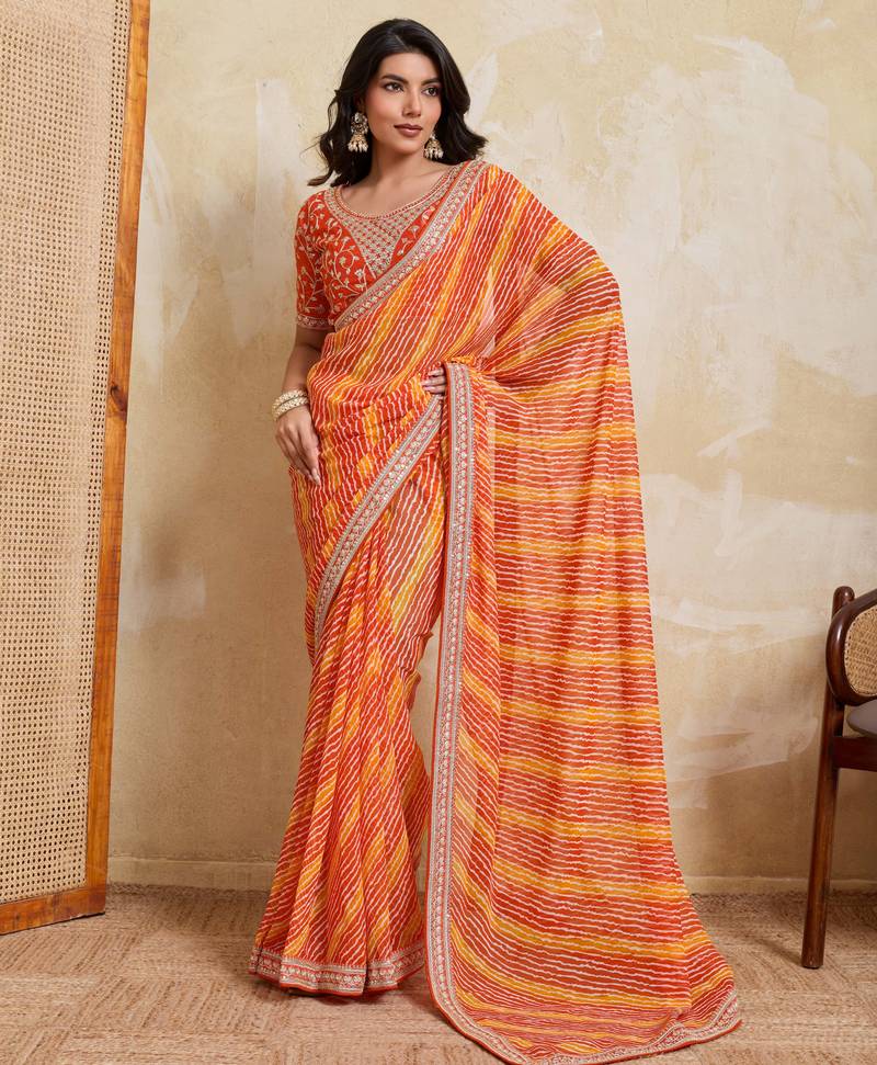 Glamourous orange georgette bandhej print with embroidery work lace border saree with mono banglory silk blouse
