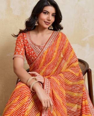 Glamourous orange georgette bandhej print with embroidery work lace border saree with mono banglory silk blouse 2