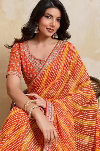 Glamourous orange georgette bandhej print with embroidery work lace border saree with mono banglory silk blouse