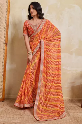 Glamourous orange georgette bandhej print with embroidery work lace border saree with mono banglory silk blouse