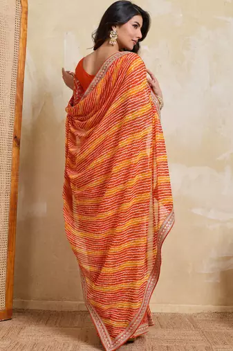 Glamourous orange georgette bandhej print with embroidery work lace border saree with mono banglory silk blouse