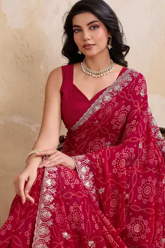 Irresistible pink georgette bandhej print with cutwork lace border saree with mono banglory silk blouse