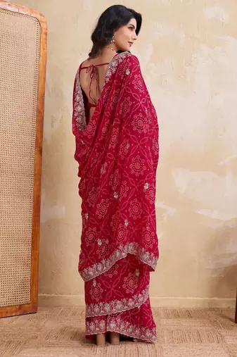 Irresistible pink georgette bandhej print with cutwork lace border saree with mono banglory silk blouse