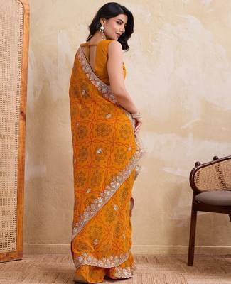 Spellbinding yellow georgette bandhej print with cutwork lace border saree with mono banglory silk blouse 4