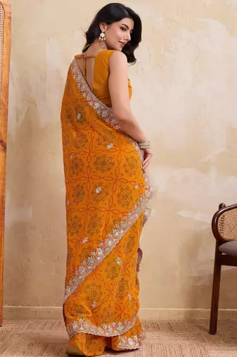 Spellbinding yellow georgette bandhej print with cutwork lace border saree with mono banglory silk blouse