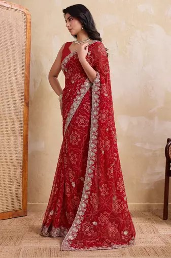Entrancing red georgette bandhej print with cutwork lace border saree with mono banglory silk blouse