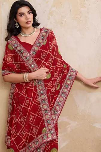 Fascinating red georgette bandhej print with cutwork lace border saree with mono banglory silk blouse