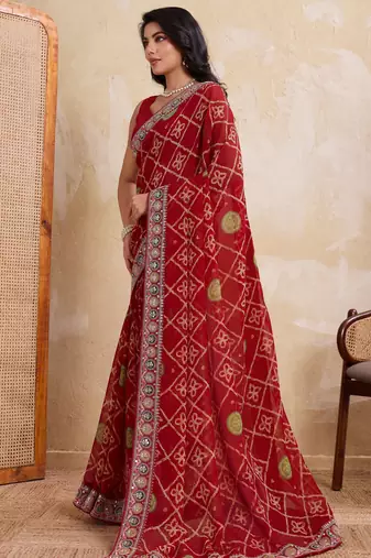 Fascinating red georgette bandhej print with cutwork lace border saree with mono banglory silk blouse