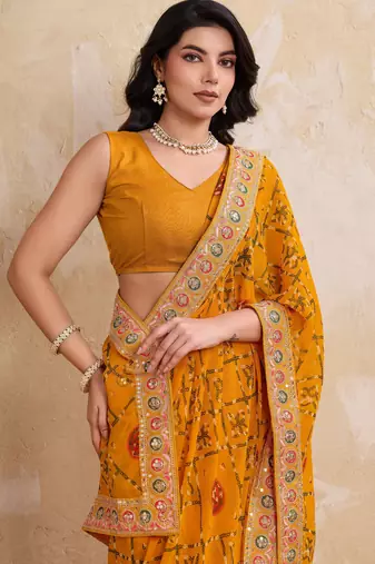 Intriguing yellow georgette bandhej print with cutwork lace border saree with mono banglory silk blouse