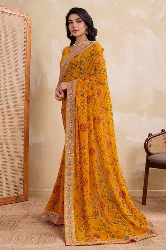Intriguing yellow georgette bandhej print with cutwork lace border saree with mono banglory silk blouse