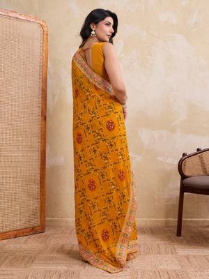 Intriguing yellow georgette bandhej print with cutwork lace border saree with mono banglory silk blouse 4