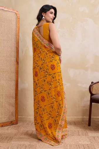 Intriguing yellow georgette bandhej print with cutwork lace border saree with mono banglory silk blouse