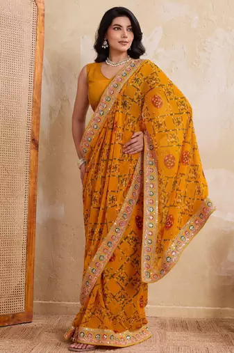 Intriguing yellow georgette bandhej print with cutwork lace border saree with mono banglory silk blouse