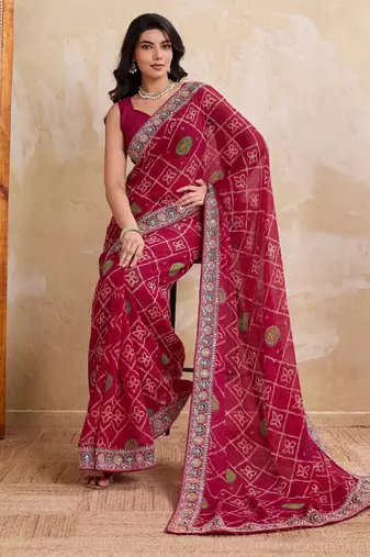 Appetizing pink georgette bandhej print with cutwork lace border saree with mono banglory silk blouse