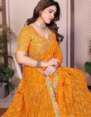 Likable yellow georgette bandhej print with cutwork lace border saree with mono banglory silk blouse 2
