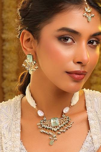Gold plated kundan green stones necklace set with maang tikka