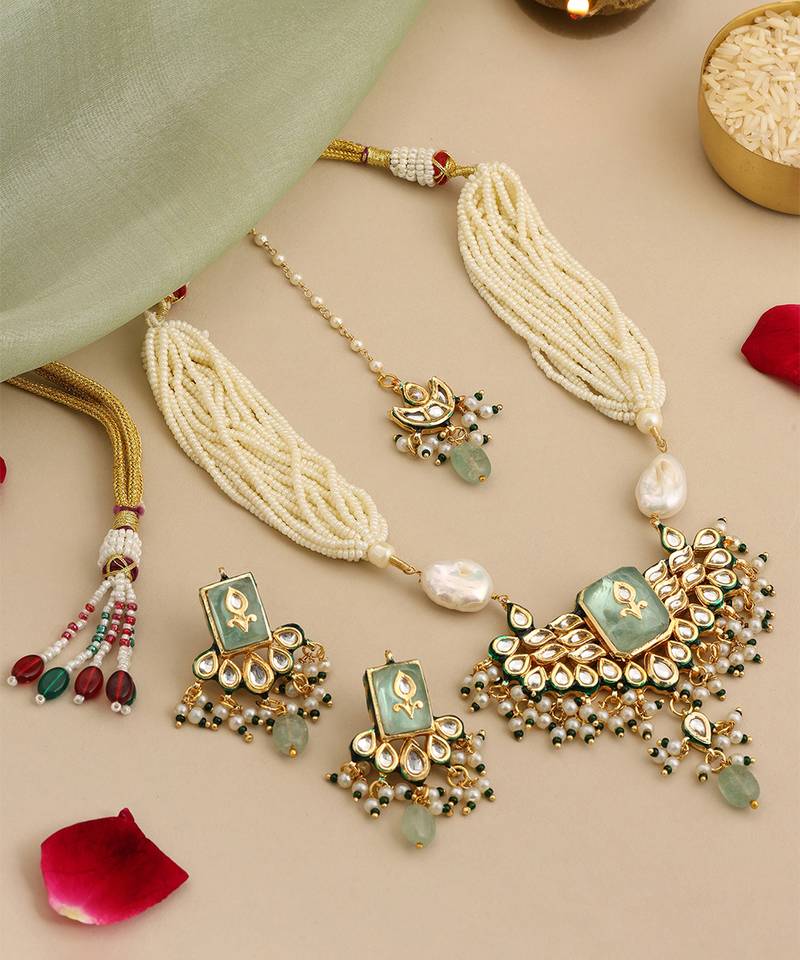 Gold plated kundan green stones necklace set with maang tikka