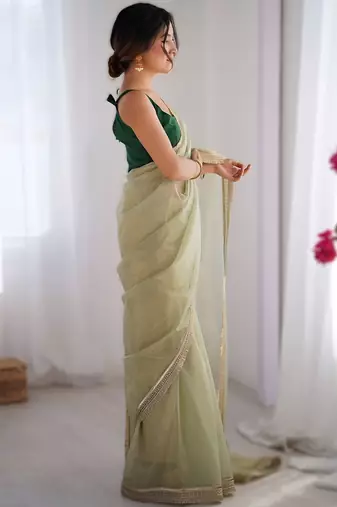 Green exclusive dual shade gold net sequins saree with lace border