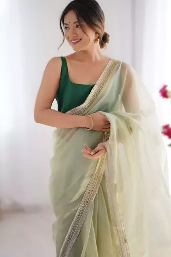 Green exclusive dual shade gold net sequins saree with lace border