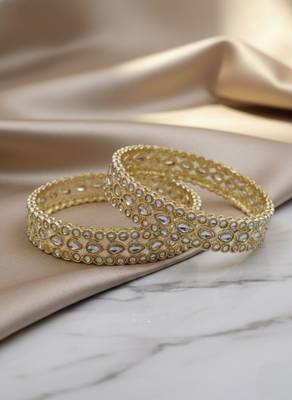 Teardrop stone-encased gold bangles 1