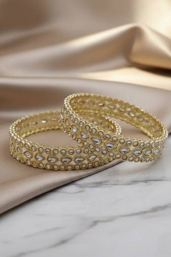 Teardrop stone-encased gold bangles