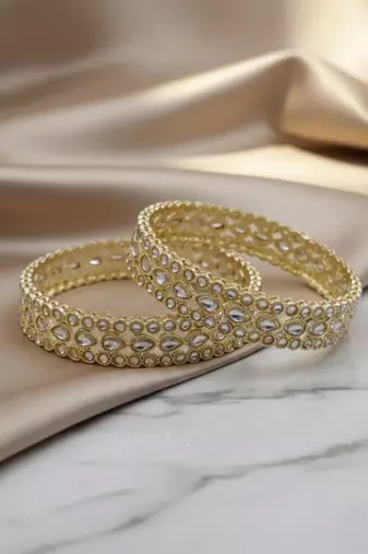 Teardrop stone-encased gold bangles