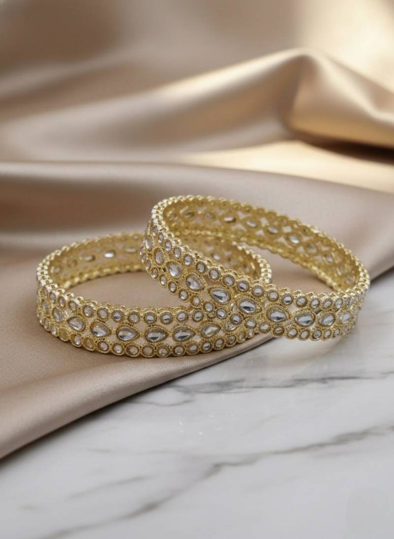 Teardrop stone-encased gold bangles