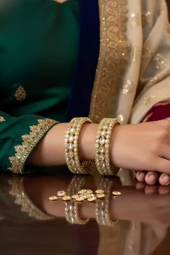 Teardrop stone-encased gold bangles