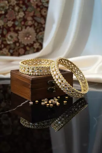 Teardrop stone-encased gold bangles