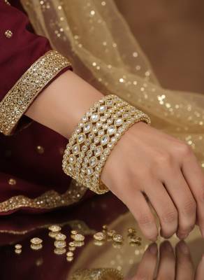 Teardrop stone-encased gold bangles 4