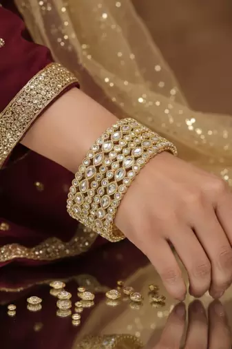 Teardrop stone-encased gold bangles