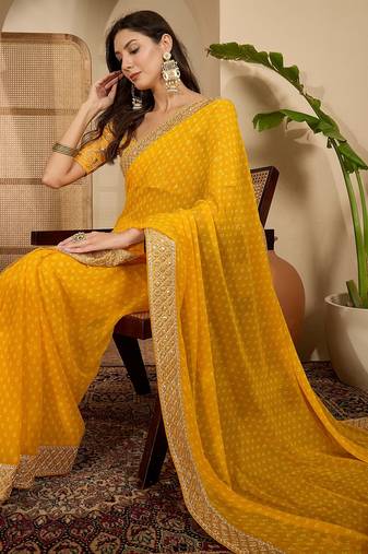 Women's gold georgette bandhni saree with unstitched blouse piece