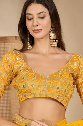 Women's gold georgette bandhni saree with unstitched blouse piece