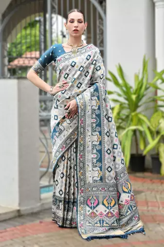 Teal banarasi silk saree in ajrakh and patola weaving with zari pallu