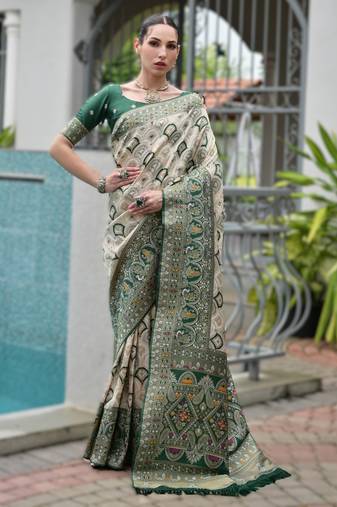 Green banarasi silk saree in ajrakh and patola weaving with zari pallu