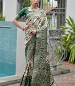 Green banarasi silk saree in ajrakh and patola weaving with zari pallu