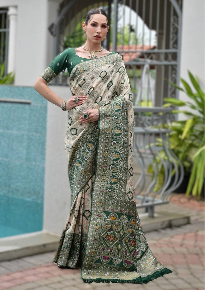 Green banarasi silk saree in ajrakh and patola weaving with zari pallu