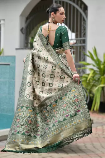 Green banarasi silk blend saree in ajrakh and patola weaving with zari pallu