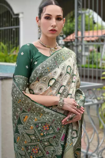 Green banarasi silk blend saree in ajrakh and patola weaving with zari pallu